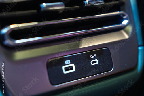 Close-up of USB-A and USB-C charging ports inside a vehicle