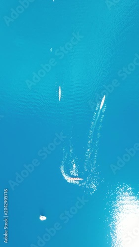 Top Down Aerial View of Rowing Boats Competing in a Race on Turquoise Sea. High quality 4k footage