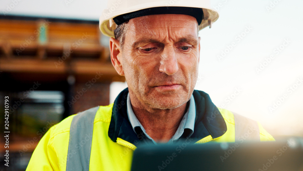 Fototapeta premium Construction, review or man on site with tablet, task instruction or inspection report in online chat. Space, ppe or mature engineer with tech, project brief or operations plan on digital platform.
