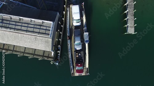 Aerial view of the Chappy Ferry carrying vehicles between wooden docks in Edgartown, Massachusetts, United States.
