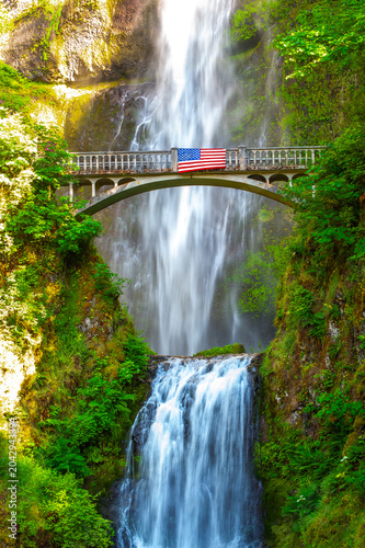 Multnomah Falls Bridge with American Flag in Lush Oregon Forest