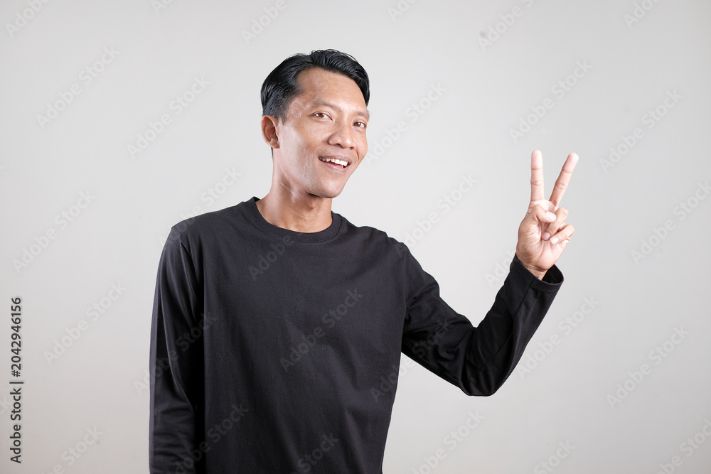 Fototapeta premium Man Showing Different Hand Gestures Isolated on Gray Background, Presentation and Communication Concept