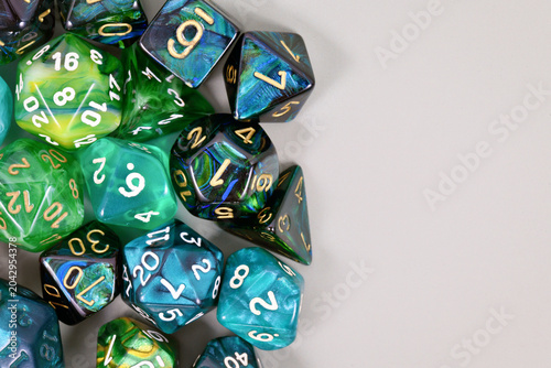 Canvas Print Blue and green roleplaying game RPG dice on side of gray background with blank c