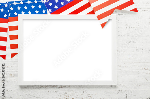 American patriotic holiday mockup with blank white frame, Usa flag bunting pennants and copy space for election, labor, independence, national celebration and promotion. Design element.