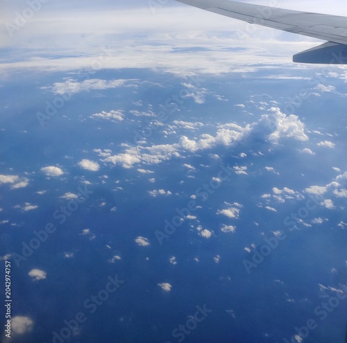 Photography Aerial view of clouds and sky with airplane wing tip