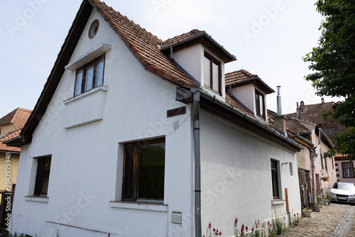 Bild auf Leinwand Traditional White European House with Dormer Windows and Tiled Roof