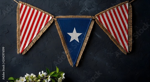 Labor Day Patriotic bunting flags with stars and stripes hanging on a dark textured wall with white flowers for Labor Day home decor