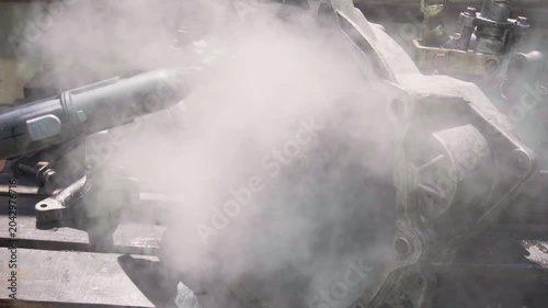 cleaning and washing with a steam cleaner of an old manual transmission from a front-wheel drive car for repair