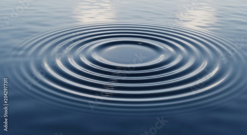A serene, tranquil body of water with gentle ripples and a single, round, dark blue rock in the center, reflecting the sky above.