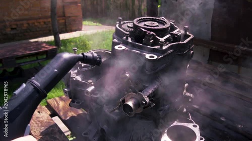 cleaning and washing with a steam cleaner of an old manual transmission from a front-wheel drive car for repair