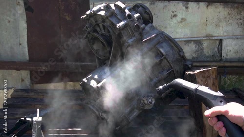 cleaning and washing with a steam cleaner of an old manual transmission from a front-wheel drive car for repair