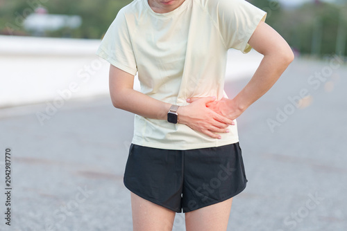 Принти на полотні Adult runner suffering from side stitch and waist pain during exercise