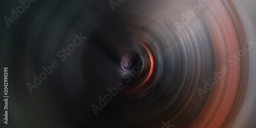 Foto Abstract circular motion blur effect with dark center and warm outer ring creating dynamic background