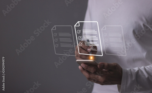 Young man with smartphone mobile hand using a pen touching to sign a Online Business Contract, Electronic signature, Contract signing, Digital documents, Future smart contract