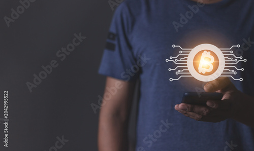 Young man using smartphone hand touching to trade cryptocurrencies online, Investors in cryptocurrencies and bitcoin coins online