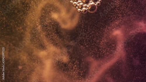 Metallic bubbles cluster with sparkling particles in warm liquid