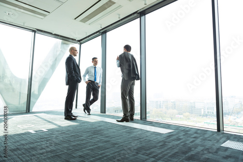 Three businessmen in office