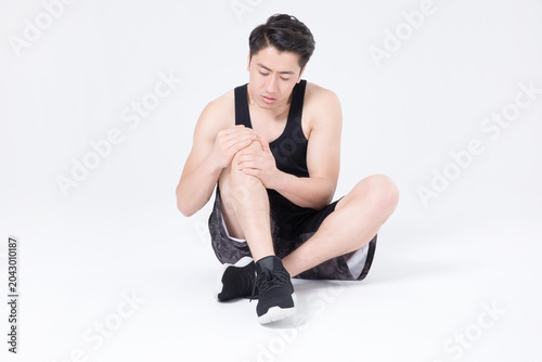 Bild auf Leinwand Athletic man suffering knee pain after workout on white background