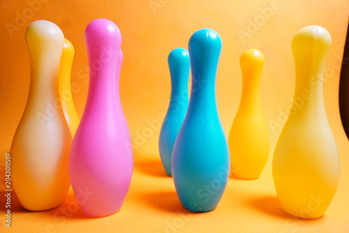 Bright colorful plastic bowling pin toys for children, promoting indoor fun, coordination skills, and playful learning activities.