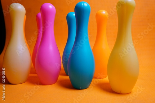 Bright colorful plastic bowling pin toys for children, promoting indoor fun, coordination skills, and playful learning activities.