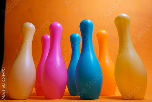 Bright colorful plastic bowling pin toys for children, promoting indoor fun, coordination skills, and playful learning activities.