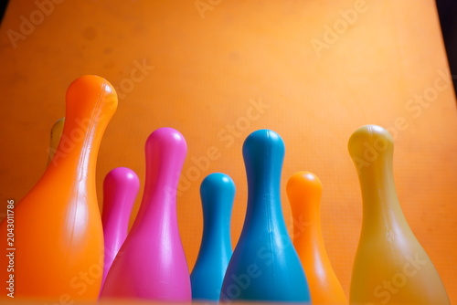 Bright colorful plastic bowling pin toys for children, promoting indoor fun, coordination skills, and playful learning activities.