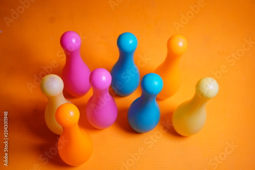 Bright colorful plastic bowling pin toys for children, promoting indoor fun, coordination skills, and playful learning activities.