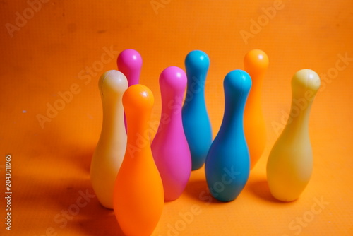 Bright colorful plastic bowling pin toys for children, promoting indoor fun, coordination skills, and playful learning activities.