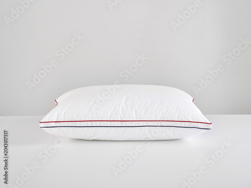 Single white pillow isolated on white background, minimal clean composition emphasizing softness, comfort, hygiene, and modern bedding product presentation with simple, elegant aesthetic style.
