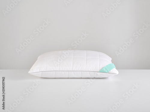 Single white pillow isolated on white background, minimal clean composition emphasizing softness, comfort, hygiene, and modern bedding product presentation with simple, elegant aesthetic style.
