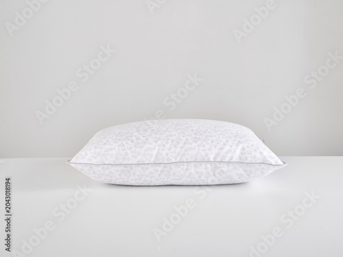 Single white pillow isolated on white background, minimal clean composition emphasizing softness, comfort, hygiene, and modern bedding product presentation with simple, elegant aesthetic style.