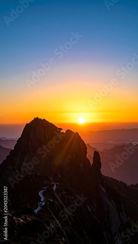 A serene mountain peak at sunrise