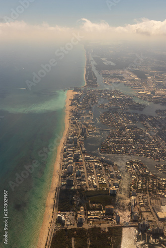 Sandy beaches and buildings on the coast of Fort Lauderdale, Florida as seen from an airplane.