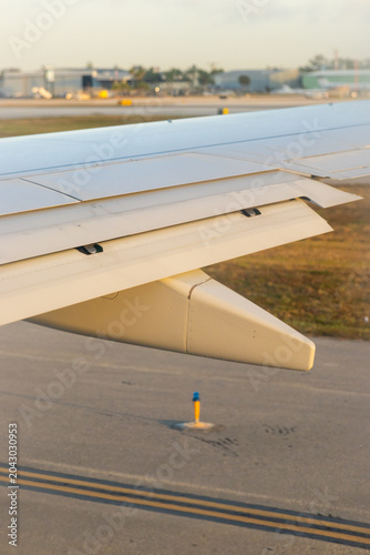 Close up of a jet engine on a while airplane wing. 