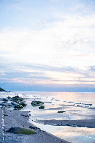 Canvas Print Rocky beach coastline on Ruegen island in Germany during sunset over the Baltic Sea