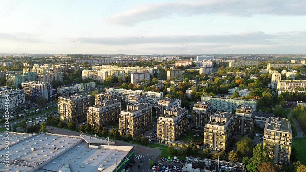 Obraz premium Drone view of city apartments and streets in sunny evening