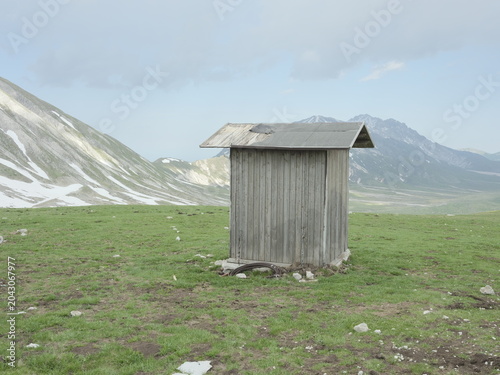 Wooden shepherd shelter in Campo Imperatore beneath the Gran Sasso mountains, Abruzzo, Italy