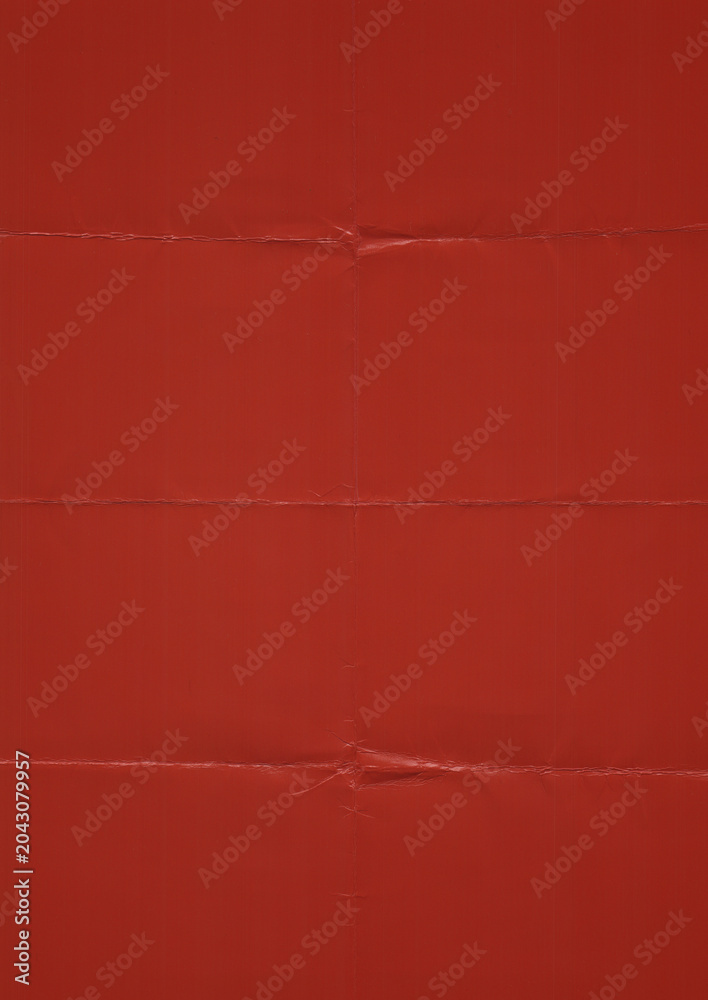 Fototapeta premium red matte photo paper texture featuring visible fold creases, subtle wrinkles, and realistic paper imperfections. The surface shows authentic folding marks and a slightly worn appearance.