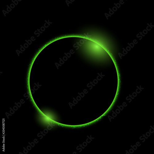 Glowing bright neon green circle frame with sparkling light particles isolated on a black background