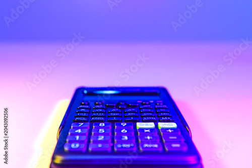 Conceptual Series : Modern calculator illuminated by vibrant digital lighting, symbolizing engineering calculations, analytical thinking, and precision driven decision making.