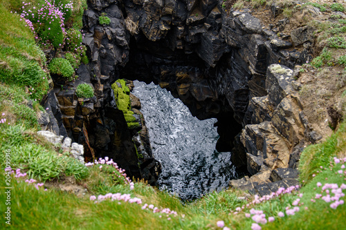 Tableau sur toile Scenic high angle view of a natural coastal blowhole and collapsed sea cave on a