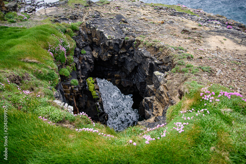 Canvas-taulu Scenic high angle view of a natural coastal blowhole and collapsed sea cave on a
