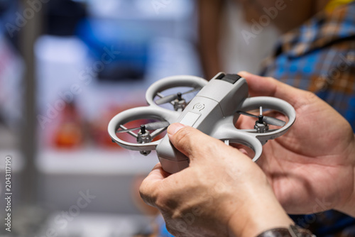 Hands Holding And Checking Small Aerial Drone