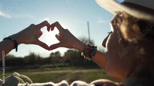 Romantic Heart Hands Capturing Golden Sunlight Flare Outdoors Vertical video