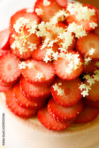 Cake topped with fresh strawberries.