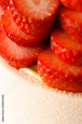 Cake topped with fresh strawberries.