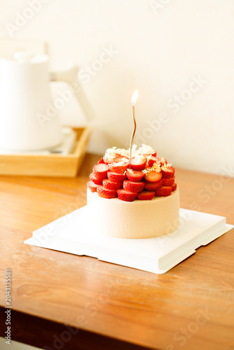 Cake topped with fresh strawberries.