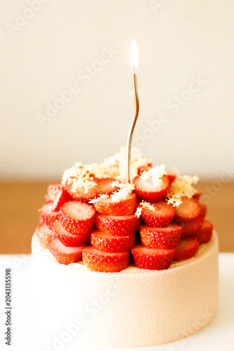 Cake topped with fresh strawberries.