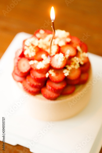 Cake topped with fresh strawberries.