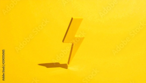 Glossy yellow lightning bolt upright against solid yellow background, casting shadow, bold monochromatic design, symbolic representation of energy, electricity, dynamic force, strength, and powerful i